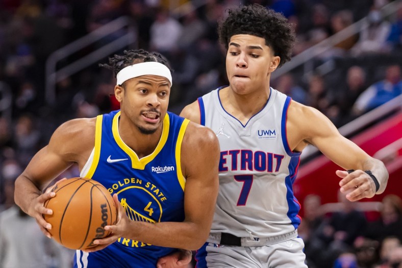Nov 19, 2021; Detroit, Michigan, USA; Golden State Warriors guard Moses Moody (4) drives to the basket against Detroit Pistons guard Killian Hayes (7) during the second quarter at Little Caesars Arena. Mandatory Credit: Raj Mehta-USA TODAY Sports