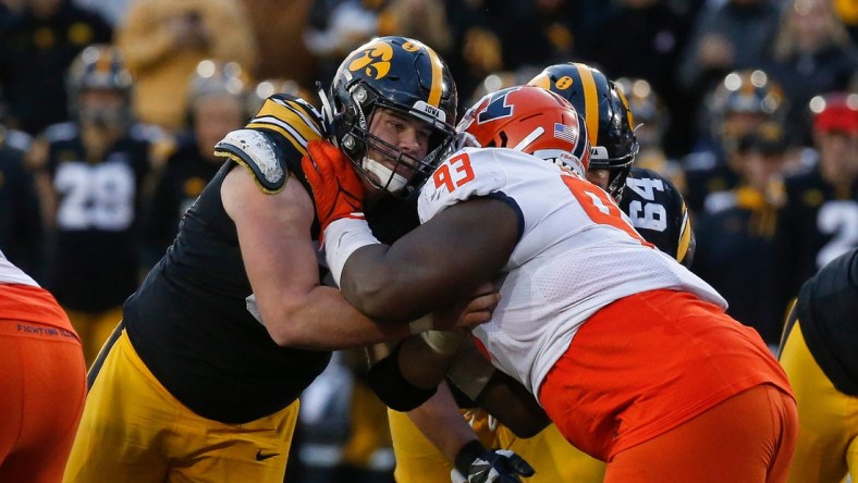 Iowa junior center Tyler Linderbaum battles Illinois junior defensive lineman Calvin Avery during a drive in the fourth quarter on Saturday, Nov. 20, 2021, at Kinnick Stadium in Iowa City, Iowa.

20211120 Iowavsillinois