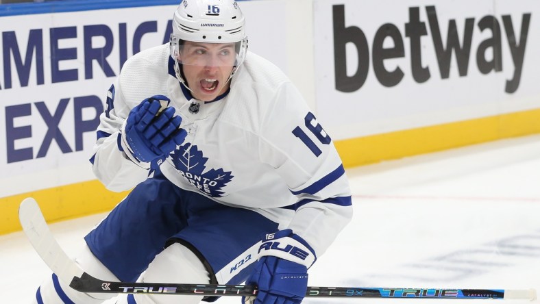 Nov 21, 2021; Elmont, New York, USA;  Toronto Maple Leafs right wing Mitchell Marner (16) celebrates after scoring a goal against New York Islanders during the first period at UBS Arena. Mandatory Credit: Tom Horak-USA TODAY Sports