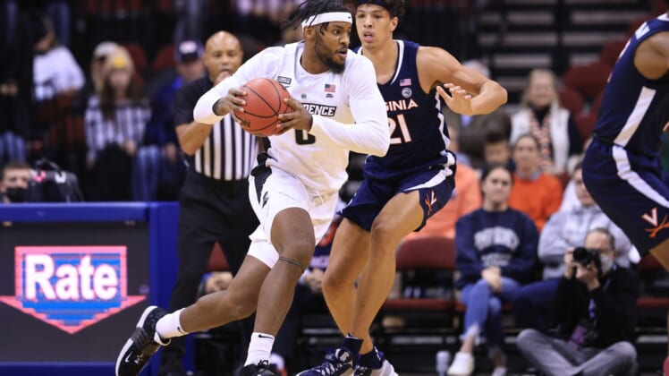 Nov 23, 2021; Newark, NJ, USA; Providence Friars center Nate Watson (0) dribbles as Virginia Cavaliers forward Kadin Shedrick (21) defends during the first half at Prudential Center. Mandatory Credit: Vincent Carchietta-USA TODAY Sports