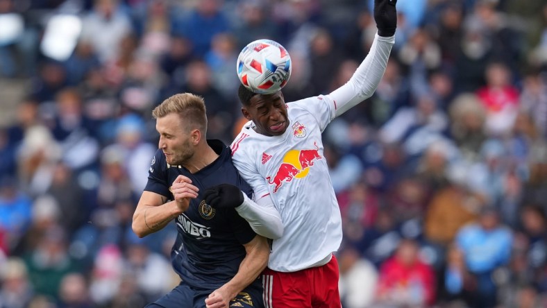 Nov 20, 2021; Chester, PA, USA; Philadelphia Union forward Kacper Przybylko (23) and New York Red Bulls defender Andres Reyes (4) attempt to play the ball off their heads in a round one MLS Playoff game at Subaru Park. Mandatory Credit: Mitchell Leff-USA TODAY Sports