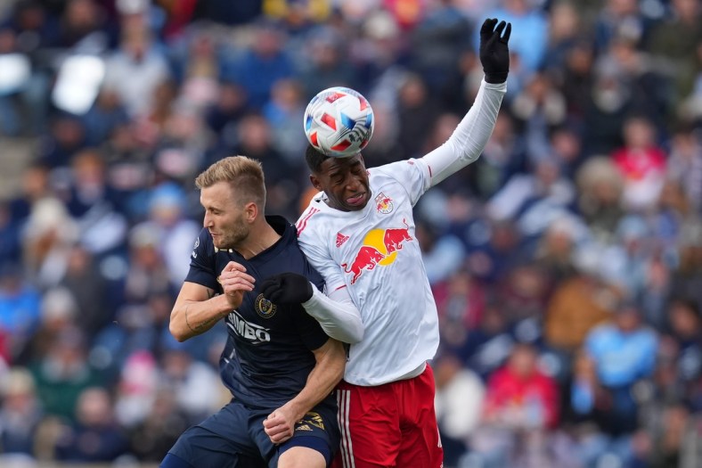 Nov 20, 2021; Chester, PA, USA; Philadelphia Union forward Kacper Przybylko (23) and New York Red Bulls defender Andres Reyes (4) attempt to play the ball off their heads in a round one MLS Playoff game at Subaru Park. Mandatory Credit: Mitchell Leff-USA TODAY Sports