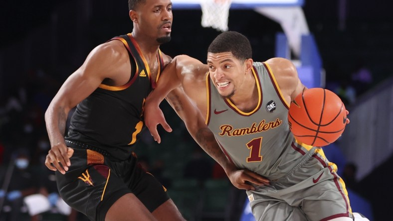 Nov 26, 2021; Nassau, BHS;  Loyola Ramblers guard Lucas Williamson (1) drives to the basket as Arizona State Sun Devils guard Luther Muhammad (1) defends during the first half in the 2021 Battle 4 Atlantis at Imperial Arena. Mandatory Credit: Kevin Jairaj-USA TODAY Sports