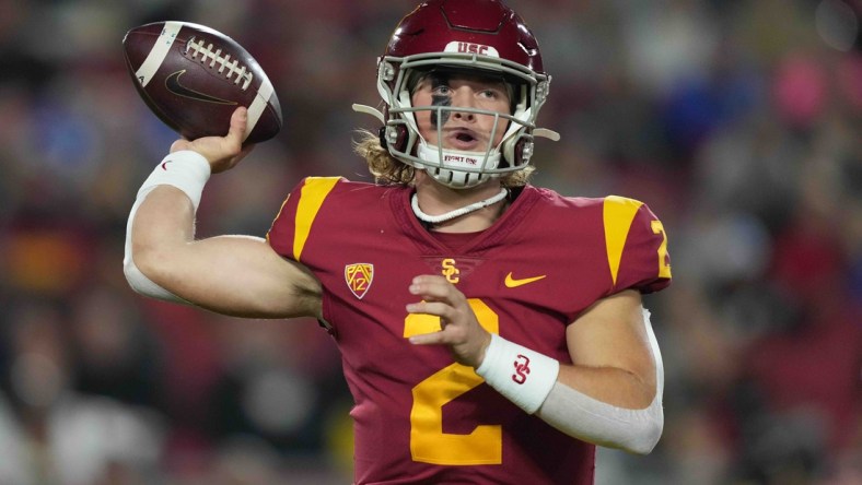 Nov 27, 2021; Los Angeles, California, USA; Southern California Trojans quarterback Jaxson Dart (2) throws the ball against the BYU Cougars in the first half at United Airlines Field at Los Angeles Memorial Coliseum. Mandatory Credit: Kirby Lee-USA TODAY Sports