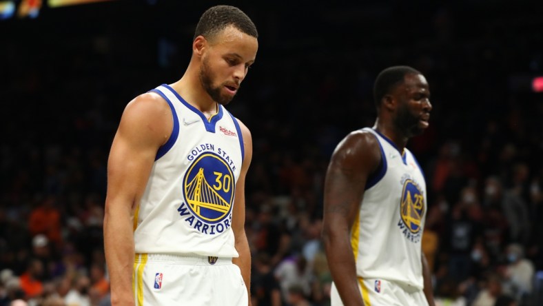 Nov 30, 2021; Phoenix, Arizona, USA; Golden State Warriors guard Stephen Curry (30) and forward Draymond Green (23) walk off the court after losing to the Phoenix Suns at Footprint Center. Mandatory Credit: Mark J. Rebilas-USA TODAY Sports