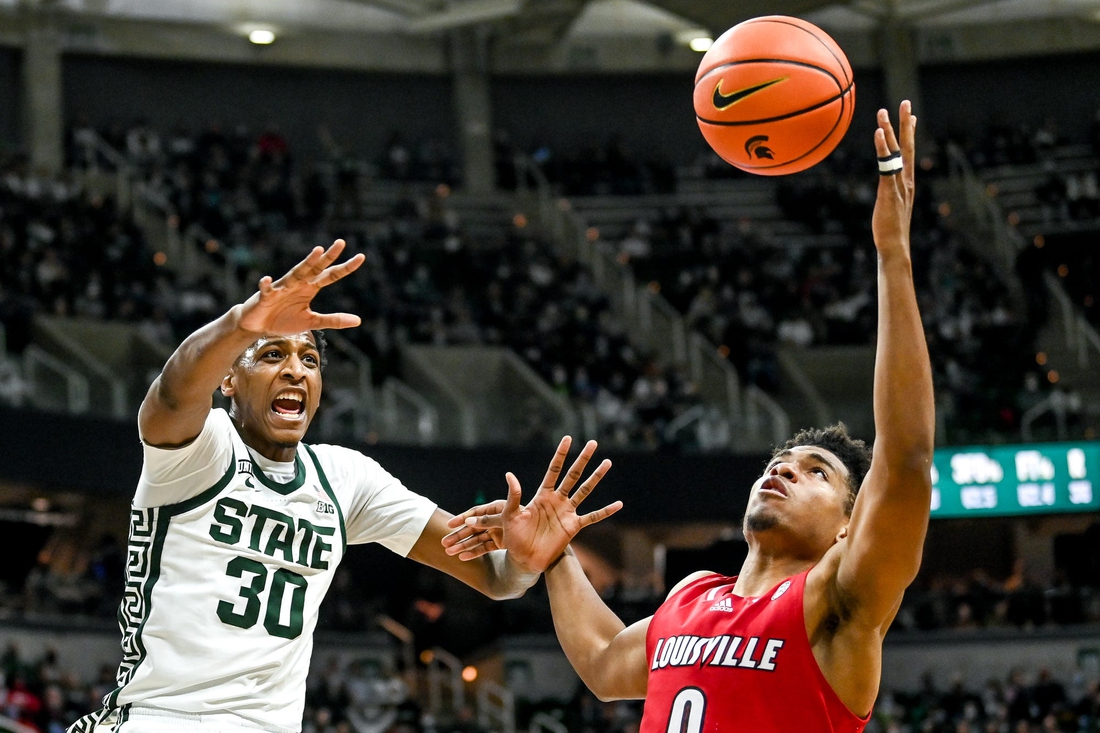 Michigan State's Marcus Bingham Jr., left, and Louisville's Noah Locke battle for a rebound during the second half on Wednesday, Dec. 1, 2021, at the Breslin Center in East Lansing.

211201 Msu Lville 160a