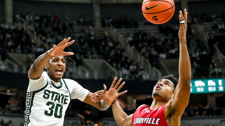 Michigan State's Marcus Bingham Jr., left, and Louisville's Noah Locke battle for a rebound during the second half on Wednesday, Dec. 1, 2021, at the Breslin Center in East Lansing.

211201 Msu Lville 160a