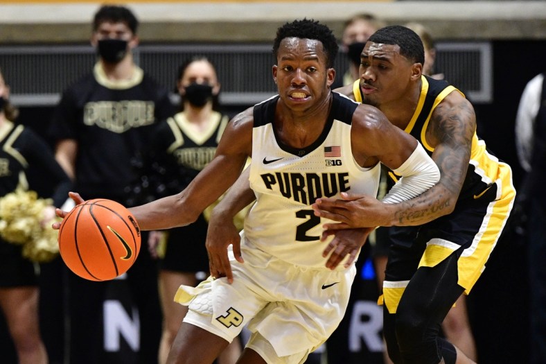 Dec 3, 2021; West Lafayette, Indiana, USA;  Iowa Hawkeyes guard Tony Perkins (11) reaches around Purdue Boilermakers guard Eric Hunter Jr. (2) in an attempt to get the ball during the second half at Mackey Arena. Boilermakers won 77-70. Mandatory Credit: Marc Lebryk-USA TODAY Sports