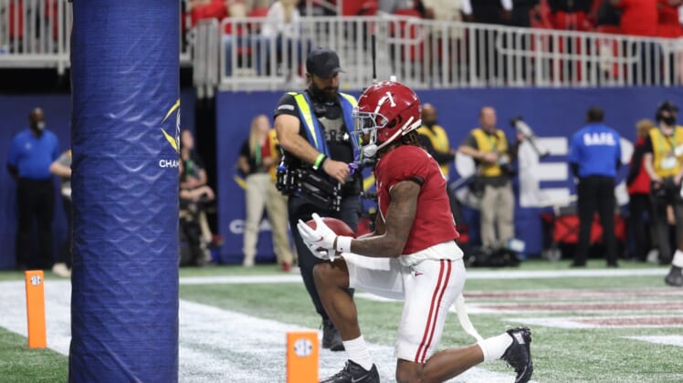 Dec 4, 2021; Atlanta, GA, USA; Alabama Crimson Tide wide receiver Jameson Williams (1) celebrates at the goal post after a receiving touchdown during the third quarter against the Georgia Bulldogs during the SEC championship game at Mercedes-Benz Stadium. Mandatory Credit: Jason Getz-USA TODAY Sports