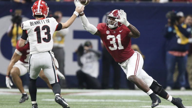 Dec 4, 2021; Atlanta, GA, USA; Georgia Bulldogs quarterback Stetson Bennett (13) throws a pass against Alabama Crimson Tide linebacker Will Anderson Jr. (31) during the SEC championship game at Mercedes-Benz Stadium. Alabama won 41-24. Mandatory Credit: Gary Cosby Jr.-USA TODAY Sports