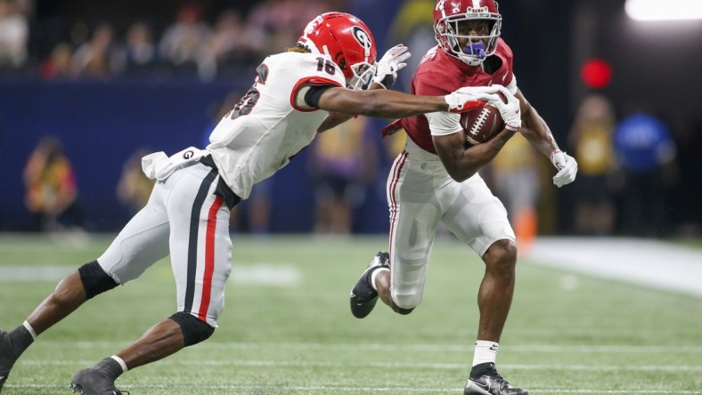 Dec 4, 2021; Atlanta, GA, USA; Alabama Crimson Tide wide receiver Ja'Corey Brooks (7) is tackled by Georgia Bulldogs defensive back Lewis Cine (16) in the second half during the SEC championship game at Mercedes-Benz Stadium. Mandatory Credit: Brett Davis-USA TODAY Sports