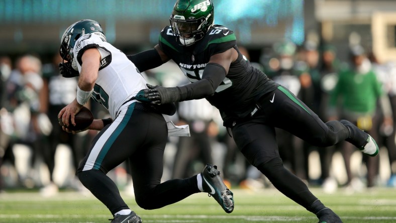 Dec 5, 2021; East Rutherford, New Jersey, USA; Philadelphia Eagles quarterback Gardner Minshew (10) is sacked by New York Jets defensive end Shaq Lawson (50) during the second quarter at MetLife Stadium. Lawson was called for a facemask penalty on the play. Mandatory Credit: Brad Penner-USA TODAY Sports