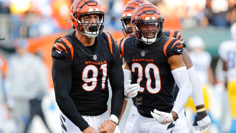 Dec 5, 2021; Cincinnati, Ohio, USA; Cincinnati Bengals defensive end Trey Hendrickson (91) celebrates the sack with cornerback Eli Apple (20) during the third quarter against the Los Angeles Chargers at Paul Brown Stadium. Mandatory Credit: Joseph Maiorana-USA TODAY Sports