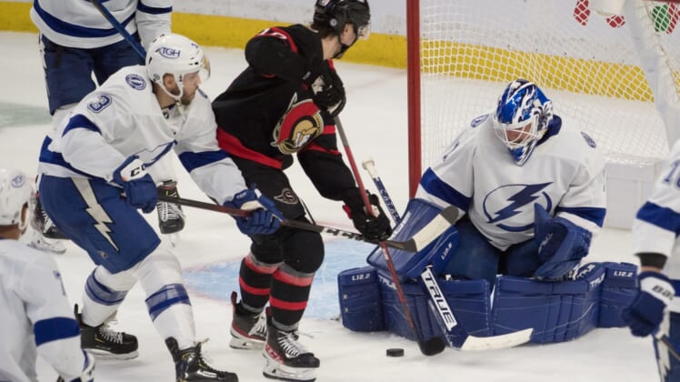 Dec 11, 2021; Ottawa, Ontario, CAN; Tampa Bay Lightning goalie Brian Elliott (1) makes a save in front of Ottawa Senators left wing Alex Formenton (10) in the third period at the Canadian Tire Centre. Mandatory Credit: Marc DesRosiers-USA TODAY Sports