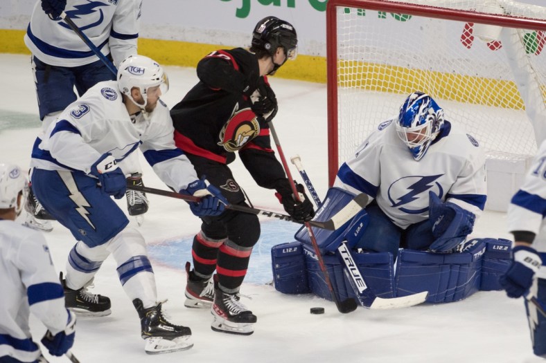 Dec 11, 2021; Ottawa, Ontario, CAN; Tampa Bay Lightning goalie Brian Elliott (1) makes a save in front of Ottawa Senators left wing Alex Formenton (10) in the third period at the Canadian Tire Centre. Mandatory Credit: Marc DesRosiers-USA TODAY Sports