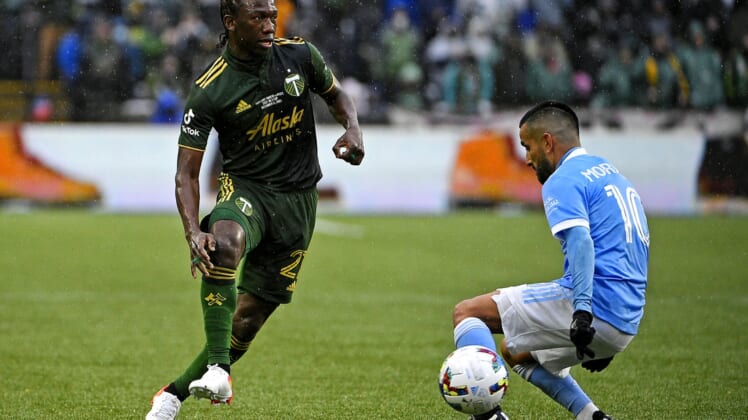 Dec 11, 2021; Portland, OR, USA; Portland Timbers midfielder Diego Chara (21) kicks the ball against New York City FC midfielder Maximiliano Moralez (10) during the first half in the 2021 MLS Cup championship game at Providence Park. Mandatory Credit: Troy Wayrynen-USA TODAY Sports