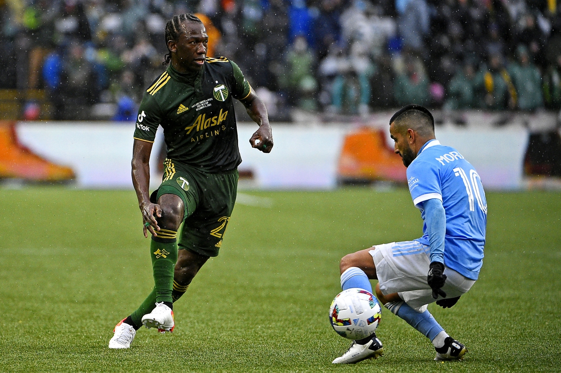 Dec 11, 2021; Portland, OR, USA; Portland Timbers midfielder Diego Chara (21) kicks the ball against New York City FC midfielder Maximiliano Moralez (10) during the first half in the 2021 MLS Cup championship game at Providence Park. Mandatory Credit: Troy Wayrynen-USA TODAY Sports