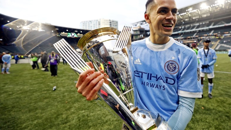 Dec 11, 2021; Portland, OR, USA; New York City FC's Jesus Medina (19) celebrates with the MLS Cup after beating the Portland Timbers in the 2021 MLS Cup championship game at Providence Park. Mandatory Credit: Soobum Im-USA TODAY Sports