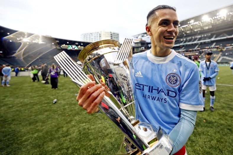 Dec 11, 2021; Portland, OR, USA; New York City FC's Jesus Medina (19) celebrates with the MLS Cup after beating the Portland Timbers in the 2021 MLS Cup championship game at Providence Park. Mandatory Credit: Soobum Im-USA TODAY Sports