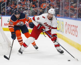 Dec 11, 2021; Edmonton, Alberta, CAN; Carolina Hurricanes forward Jordan Staal (11) looks to make a pas in front of Edmonton Oilers defensemen Markus Neimelainen (80) during the second period at Rogers Place. Mandatory Credit: Perry Nelson-USA TODAY Sports