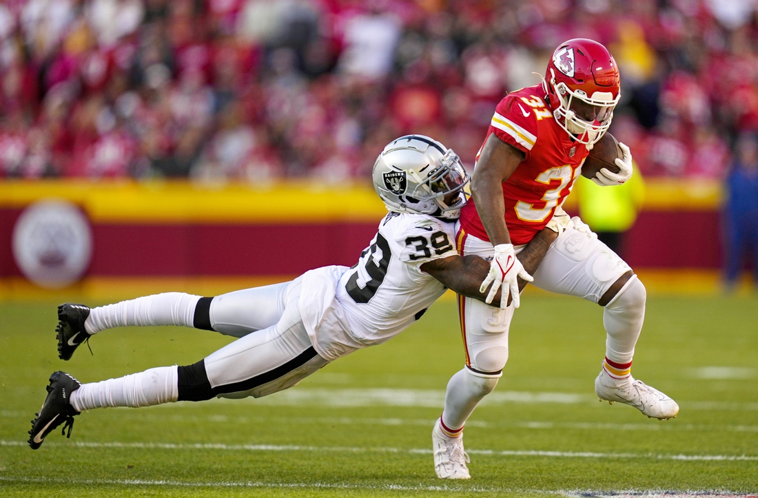 Dec 12, 2021; Kansas City, Missouri, USA; Kansas City Chiefs running back Darrel Williams (31) is tackled by Las Vegas Raiders cornerback Nate Hobbs (39) during the second half at GEHA Field at Arrowhead Stadium. Mandatory Credit: Jay Biggerstaff-USA TODAY Sports