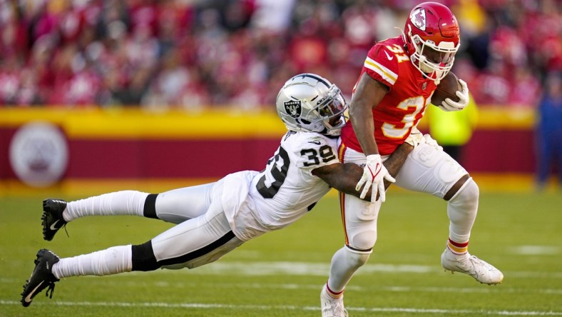 Dec 12, 2021; Kansas City, Missouri, USA; Kansas City Chiefs running back Darrel Williams (31) is tackled by Las Vegas Raiders cornerback Nate Hobbs (39) during the second half at GEHA Field at Arrowhead Stadium. Mandatory Credit: Jay Biggerstaff-USA TODAY Sports