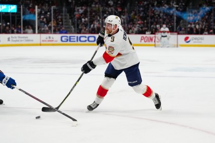 Dec 12, 2021; Denver, Colorado, USA; Florida Panthers center Sam Bennett (9) shoots the puck against the Colorado Avalanche net in the first period at Ball Arena. Mandatory Credit: Ron Chenoy-USA TODAY Sports