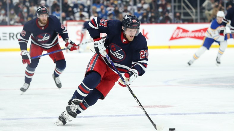 Dec 14, 2021; Winnipeg, Manitoba, CAN;  Winnipeg Jets forward Nikolaj Ehlers (27) skates into the Buffalo Sabres zone during the second period at Canada Life Centre. Mandatory Credit: Terrence Lee-USA TODAY Sports