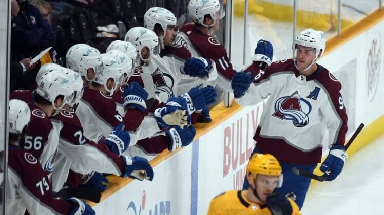 Dec 16, 2021; Nashville, Tennessee, USA; Colorado Avalanche players celebrate after a goal by right wing Mikko Rantanen (96) during the second period against the Nashville Predators at Bridgestone Arena. Mandatory Credit: Christopher Hanewinckel-USA TODAY Sports
