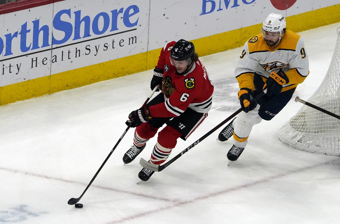 Dec 17, 2021; Chicago, Illinois, USA; Nashville Predators left wing Filip Forsberg (9) defends Chicago Blackhawks defenseman Jake McCabe (6) during the second period at United Center. Mandatory Credit: David Banks-USA TODAY Sports