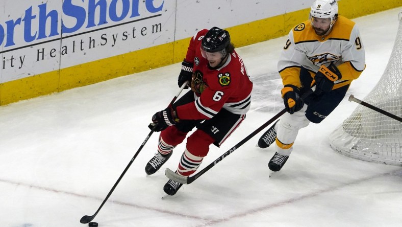 Dec 17, 2021; Chicago, Illinois, USA; Nashville Predators left wing Filip Forsberg (9) defends Chicago Blackhawks defenseman Jake McCabe (6) during the second period at United Center. Mandatory Credit: David Banks-USA TODAY Sports