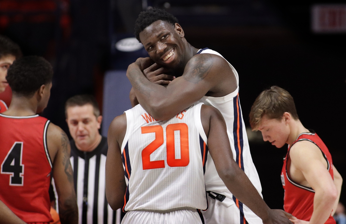 Dec 18, 2021; Champaign, Illinois, USA;  Illinois Fighting Illini center Kofi Cockburn (21) hugs teammate Da'Monte Williams (20) during the second half against the Saint Francis Red Flash at State Farm Center. Mandatory Credit: Ron Johnson-USA TODAY Sports