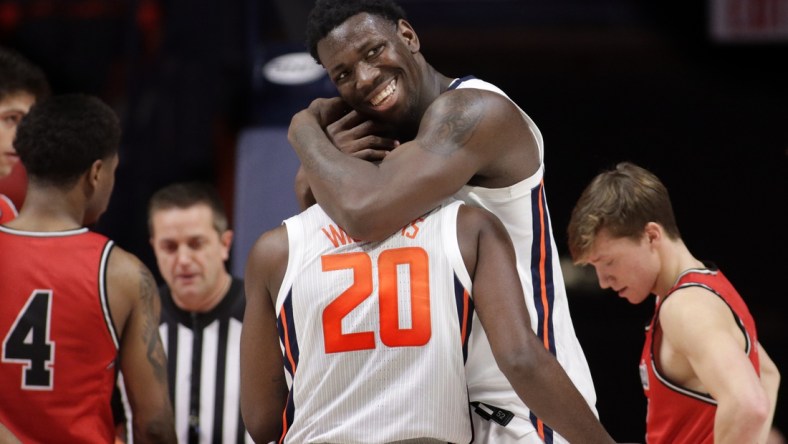 Dec 18, 2021; Champaign, Illinois, USA;  Illinois Fighting Illini center Kofi Cockburn (21) hugs teammate Da'Monte Williams (20) during the second half against the Saint Francis Red Flash at State Farm Center. Mandatory Credit: Ron Johnson-USA TODAY Sports