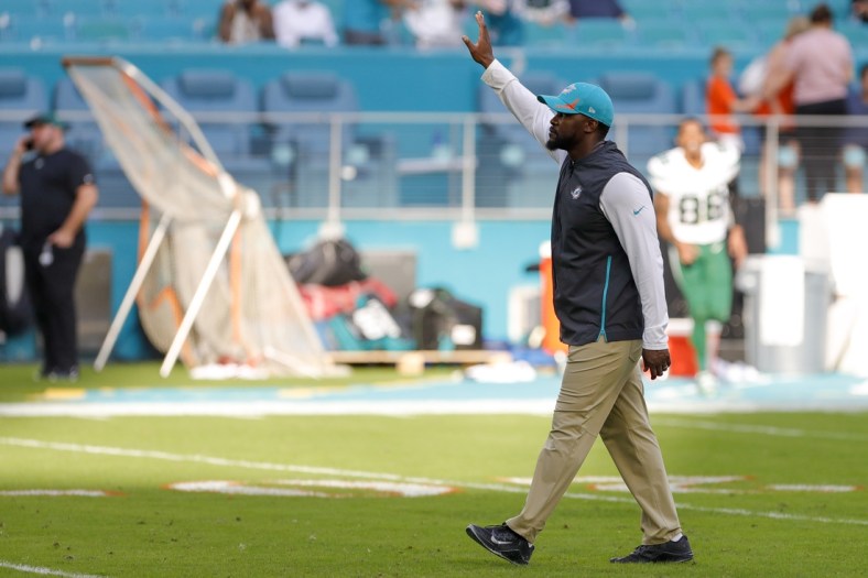 Dec 19, 2021; Miami Gardens, Florida, USA; Miami Dolphins head coach Brian Flores waves at fans after winning the game against the New York Jets at Hard Rock Stadium. Mandatory Credit: Sam Navarro-USA TODAY Sports