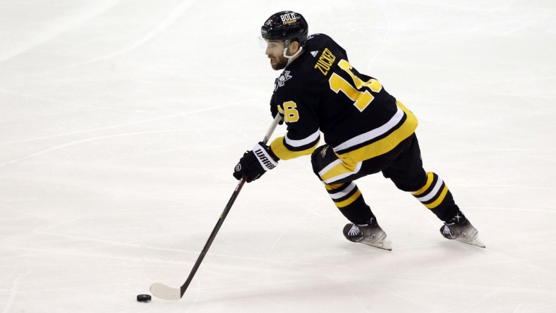 Dec 17, 2021; Pittsburgh, Pennsylvania, USA;  Pittsburgh Penguins left wing Jason Zucker (16) skates with the puck against the Buffalo Sabres during the second period at PPG Paints Arena. Mandatory Credit: Charles LeClaire-USA TODAY Sports