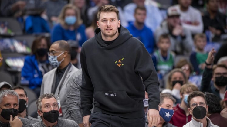 Dec 21, 2021; Dallas, Texas, USA; Dallas Mavericks guard Luka Doncic (77) watches from the team bench during the first quarter of the game between the Dallas Mavericks and the Minnesota Timberwolves at the American Airlines Center. Mandatory Credit: Jerome Miron-USA TODAY Sports