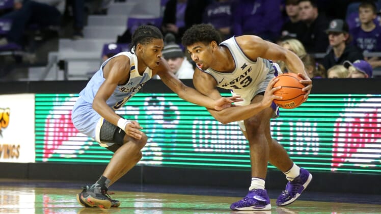 Dec 21, 2021; Manhattan, Kansas, USA; Kansas State Wildcats guard Mark Smith (13) is guarded by McNeese State Cowboys guard Trae English (0) during the second half at Bramlage Coliseum. Mandatory Credit: Scott Sewell-USA TODAY Sports