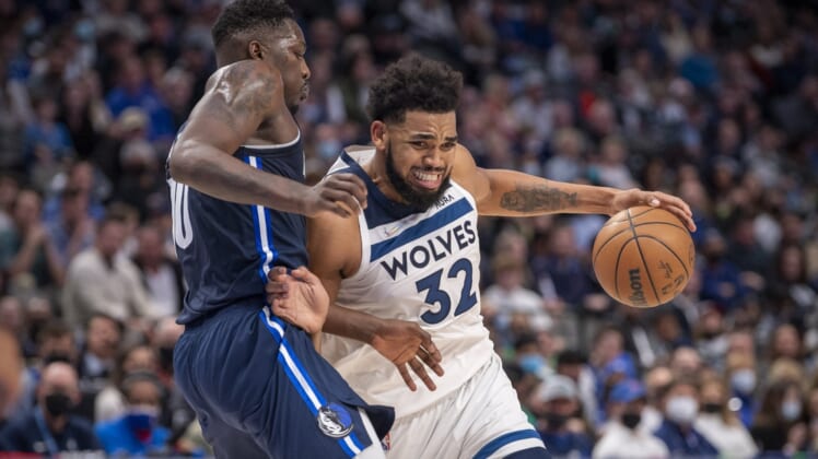 Dec 21, 2021; Dallas, Texas, USA; Minnesota Timberwolves center Karl-Anthony Towns (32) drives to the basket past Dallas Mavericks forward Dorian Finney-Smith (10) during the second half at the American Airlines Center. Mandatory Credit: Jerome Miron-USA TODAY Sports