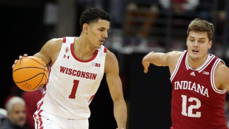 Dec 8, 2021; Madison, Wisconsin, USA; Wisconsin Badgers guard Johnny Davis (1) dribbles the ball as Indiana Hoosiers forward Miller Kopp (12) defends at the Kohl Center. Mandatory Credit: Mary Langenfeld-USA TODAY Sports