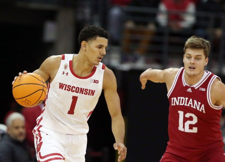 Dec 8, 2021; Madison, Wisconsin, USA; Wisconsin Badgers guard Johnny Davis (1) dribbles the ball as Indiana Hoosiers forward Miller Kopp (12) defends at the Kohl Center. Mandatory Credit: Mary Langenfeld-USA TODAY Sports