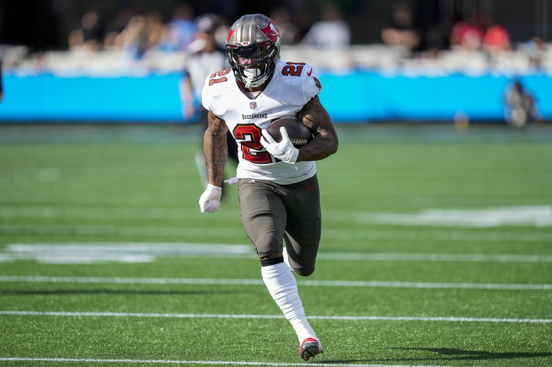 Dec 26, 2021; Charlotte, North Carolina, USA; Tampa Bay Buccaneers running back Ke'Shawn Vaughn (21) runs for a touchdown against the Carolina Panthers during the first quarter at Bank of America Stadium. Mandatory Credit: Jim Dedmon-USA TODAY Sports