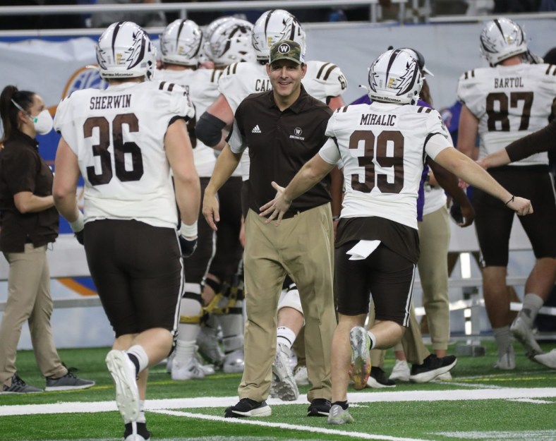 Western Michigan head coach Tim Lester congratulates his players Monday, Dec. 27, 2021, during the Broncos' 52-24 win over the Nevada Wolf Pack in the Quick Lane Bowl at Ford Field.

Quick Lane
