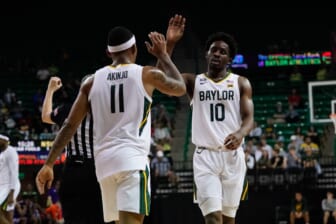 Dec 28, 2021; Waco, Texas, USA;  Baylor Bears guard James Akinjo (11) and guard Adam Flagler (10) celebrate after a play during the second half at Ferrell Center. Mandatory Credit: Chris Jones-USA TODAY Sports
