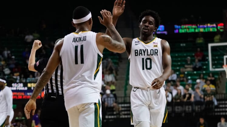 Dec 28, 2021; Waco, Texas, USA;  Baylor Bears guard James Akinjo (11) and guard Adam Flagler (10) celebrate after a play during the second half at Ferrell Center. Mandatory Credit: Chris Jones-USA TODAY Sports