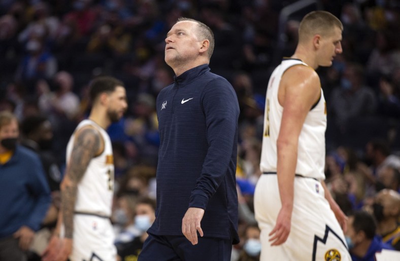 Dec 28, 2021; San Francisco, California, USA; Denver Nuggets head coach Michael Malone watches a replay after calling a timeout during the first quarter against the Golden State Warriors at Chase Center. Mandatory Credit: D. Ross Cameron-USA TODAY Sports