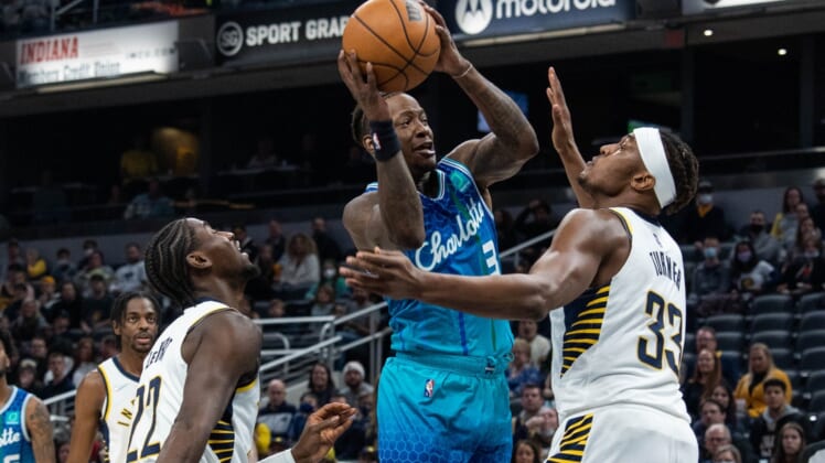 Dec 29, 2021; Indianapolis, Indiana, USA; Charlotte Hornets guard Terry Rozier (3) shoots against ndiana Pacers center Myles Turner (33) in the first quarter at Gainbridge Fieldhouse. Mandatory Credit: Trevor Ruszkowski-USA TODAY Sports