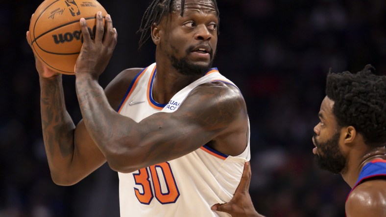 Dec 29, 2021; Detroit, Michigan, USA; New York Knicks forward Julius Randle (30) gets defended by Detroit Pistons guard Derrick Walton Jr. (25) during the second quarter at Little Caesars Arena. Mandatory Credit: Raj Mehta-USA TODAY Sports