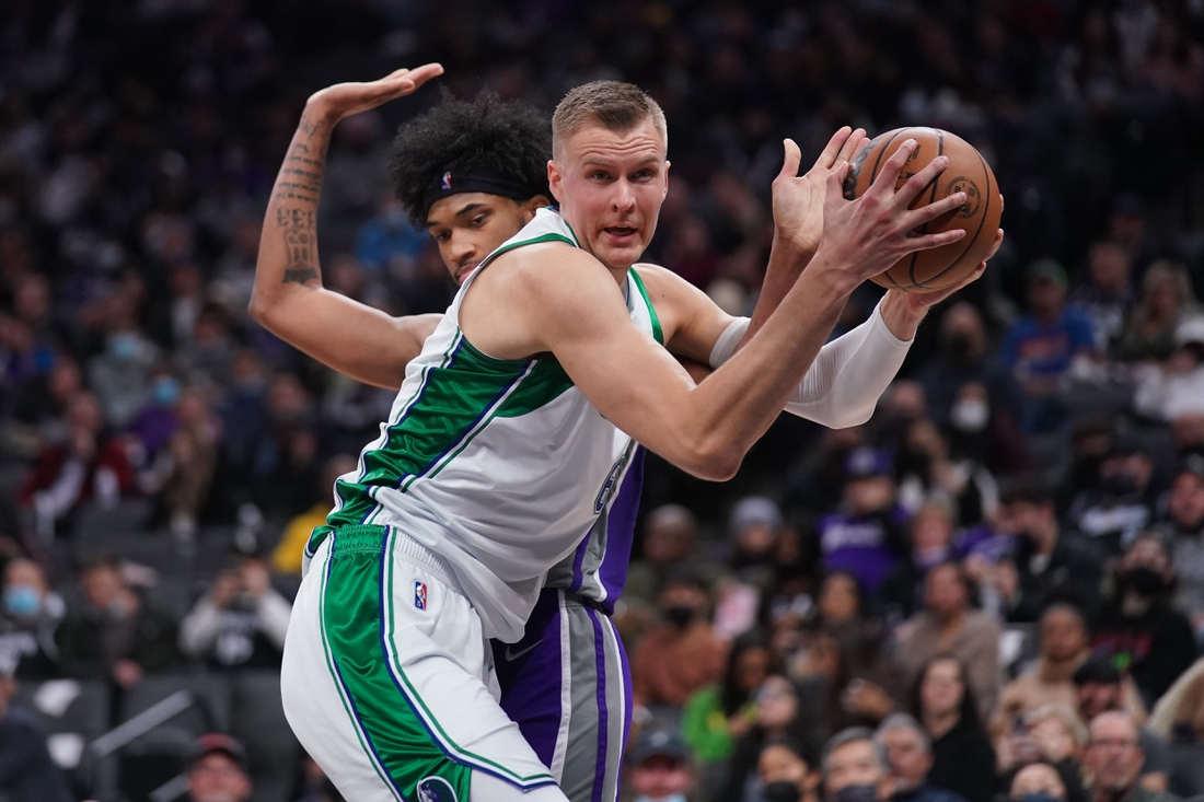 Dec 29, 2021; Sacramento, California, USA; Dallas Mavericks center Kristaps Porzingis (6) holds onto a rebound in front of Sacramento Kings forward Marvin Bagley III (35) in the third quarter at the Golden 1 Center. Mandatory Credit: Cary Edmondson-USA TODAY Sports