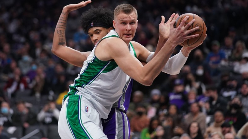 Dec 29, 2021; Sacramento, California, USA; Dallas Mavericks center Kristaps Porzingis (6) holds onto a rebound in front of Sacramento Kings forward Marvin Bagley III (35) in the third quarter at the Golden 1 Center. Mandatory Credit: Cary Edmondson-USA TODAY Sports