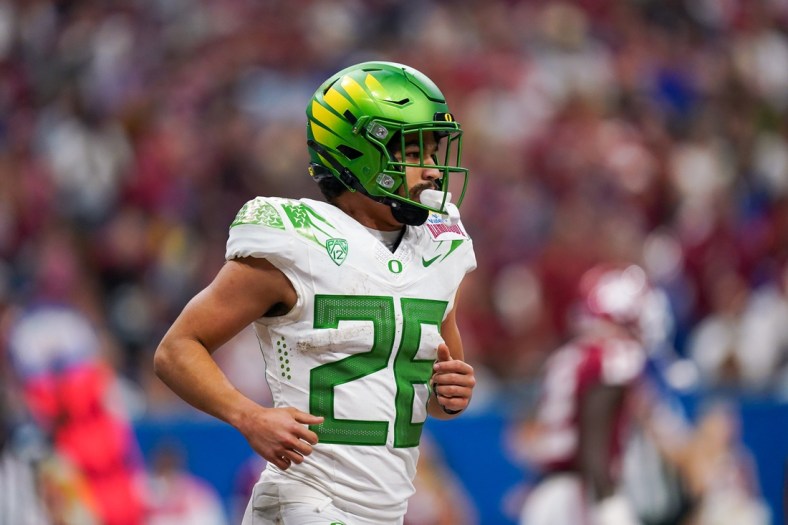 Dec 29, 2021; San Antonio, Texas, USA; Oregon Ducks running back Travis Dye (26) runs off the field after scoring a touchdown during the second half of the 2021 Alamo Bowl against he Oklahoma Sooners at the Alamodome. Mandatory Credit: Daniel Dunn-USA TODAY Sports